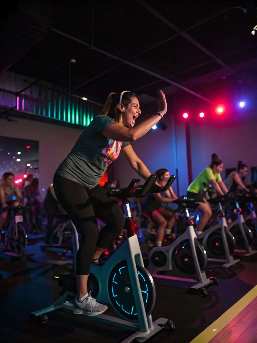 An energetic image of a Les Mills RPM class, featuring cyclists pedaling intensely on stationary bikes, highlighting the cardio benefits and immersive experience of the workout.